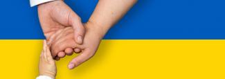 mains d'homme, femme et enfant qui se tiennent devant le drapeau ukrainien